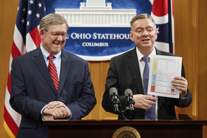 Ohio State Reps. Bob Cupp, R-Lima, left, and John Patterson, D-Jefferson, announce their proposed overhaul of Ohio's school funding formula at the Statehouse in Columbus, Monday, March 25, 2019. 