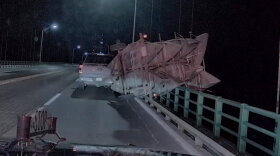 Pickup truck with tipped-over trailer on the Mackinac Bridge.