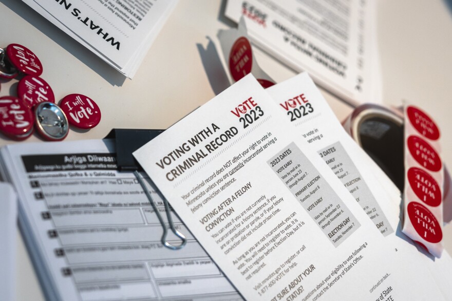 Minnesota voter registration application forms and informational brochures for "voting with a criminal record" are displayed during a "Restore the Vote" rally at Arlington Hills Community Center in St. Paul, Minn.