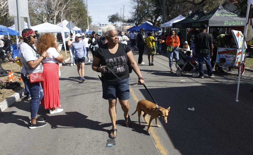 Festival attendees walk during the 2022 Publix Tampa Bay Collard Festival in St. Petersburg, Florida, on Saturday, February 19, 2022. Photo by Octavio Jones for WUSF