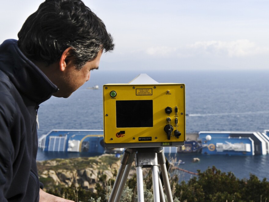 Technician Andera Faccioli positioned a laser-equipped device to determine whether the Costa Concordia has shifted position off the Tuscan island of Giglio, Italy.