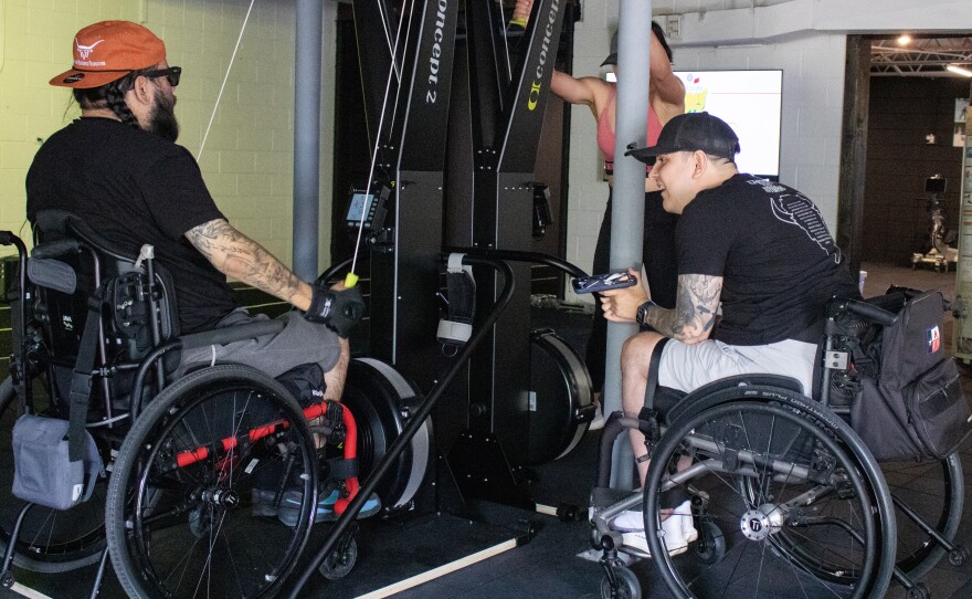 Waco Adapt co-founder Edwin Munoz, center, chats with Nick Salazar during a group workout on April 8, 2026. Munoz helps design and run the workout plans for each of the group sessions.