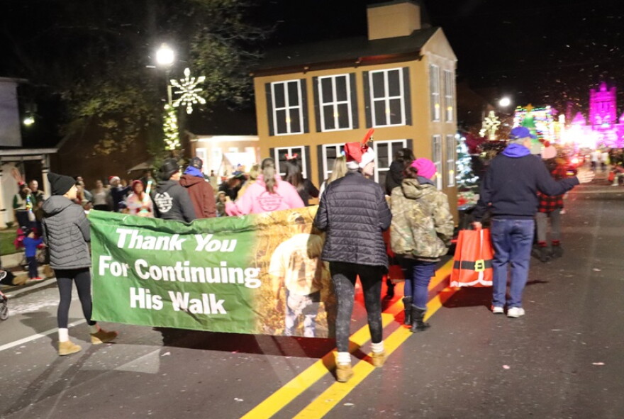 Members of the Ballard family walk in Thursday’s Bardstown Christmas Parade. Tommy Ballard was shot to death while hunting in 2016; his daughter Crystal Rogers disappeared in 2015.