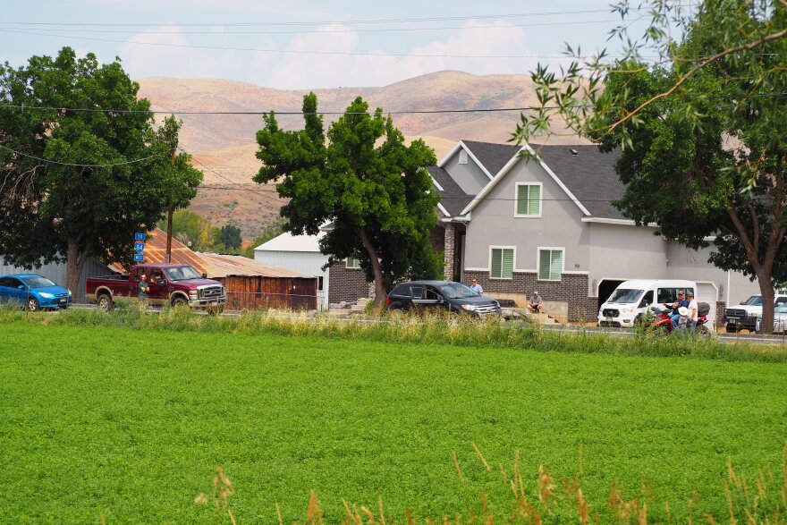 Residents gather along Main Street in Henefer, watching the Rocky Canyon Fire on Aug. 10, 2026.