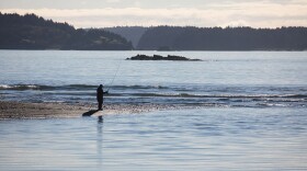 A fisherman at the mouth of the Buskin River. (Photo by Lisa Hupp/USFWS)
