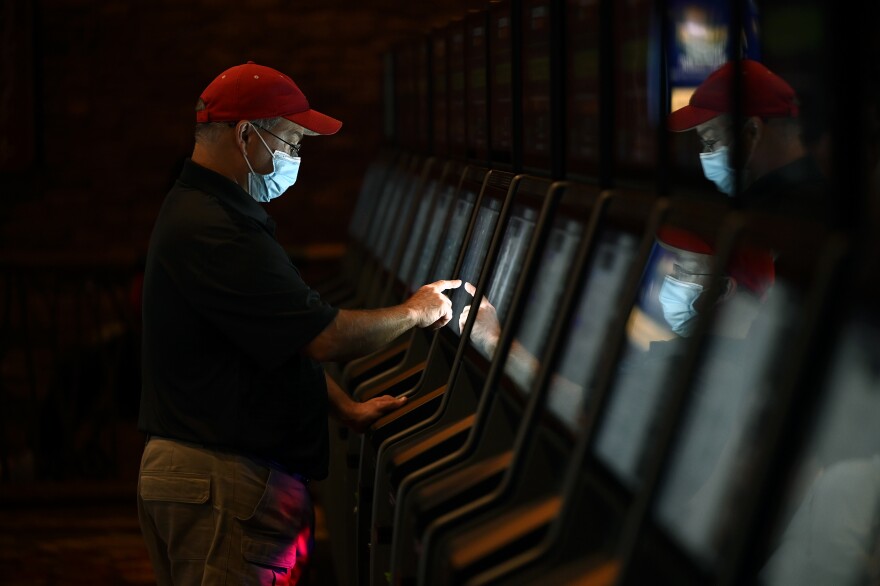 John Seaton 59, of New York looking through the menus as Sports Betting operators allowed patrons to place bets during a soft launch at Mohegan Sun September 30, 2021 in Uncasville, Connecticut.