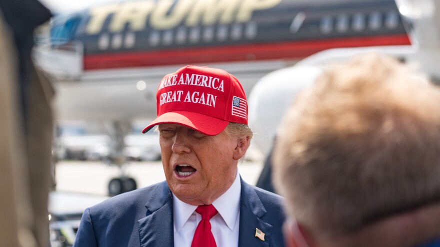Former President Donald Trump speaks to the media as he arrives at the airport on Wednesday in Atlanta, Georgia. Trump is visiting Atlanta for a campaign fundraising event he is hosting.