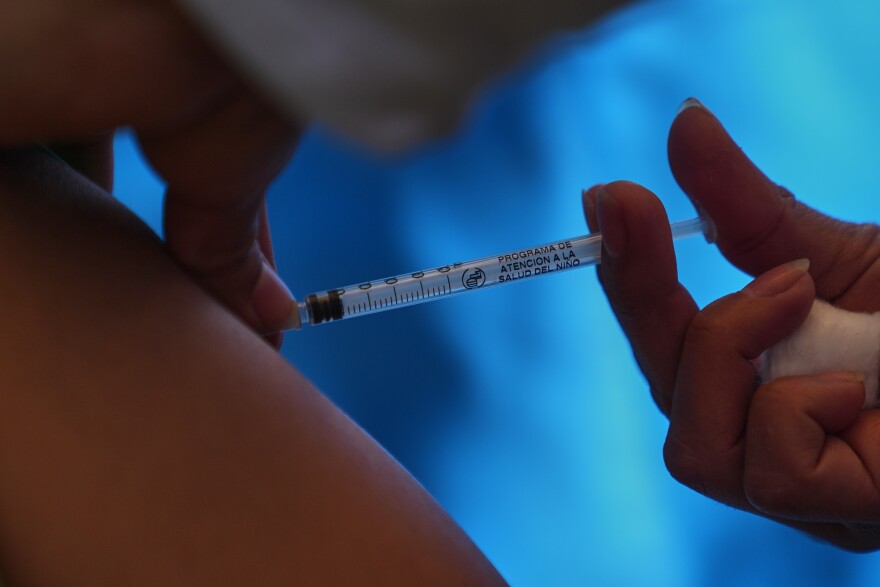 A health worker administers a dose of the measles vaccine in Chapultepec Park in Mexico City, Sunday, Feb. 8, 2026.