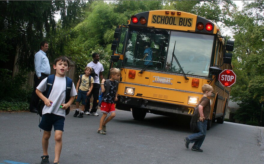 A picture of children getting off a school bus.