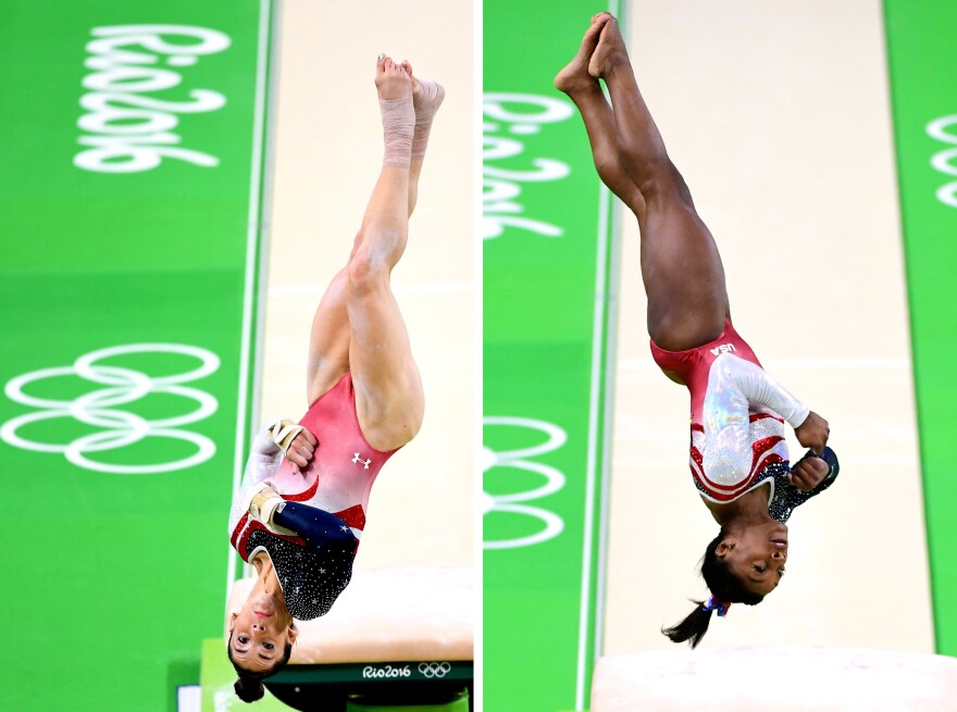 Aly Raisman (left) and Simone Biles (right) of the United States compete on the vault during the women's team final.