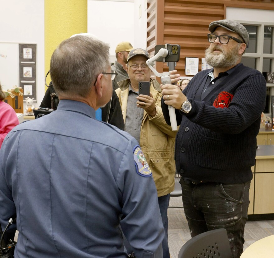 Coweta Police Chief Mike Bell chats with YouTuber Ron Durbin after the Coweta School Board meeting on Nov. 10. Durbin was attempting to conduct a citizen's arrest after someone allegedly touched his son/cameraman during the event.