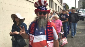 Boeing worker Michael McNeil waits in line Tuesday afternoon to get into Everett's Xfinity Arena to hear Donald Trump speak.
