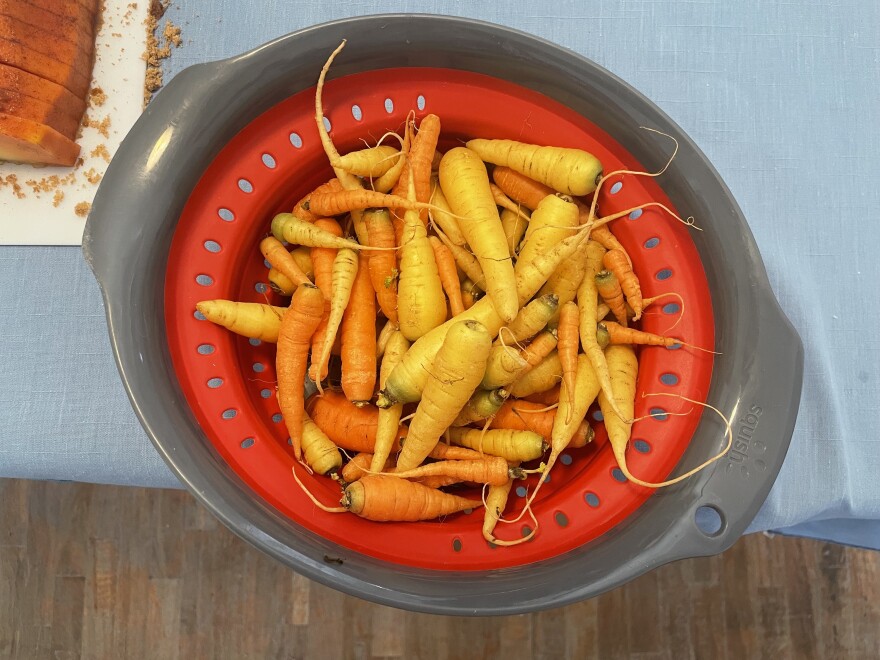 Jasmyne Muñoz washes carrots grown at La Plazita. Later, she'll juice them and bring them to young people in Albuquerque's juvenile detention center.