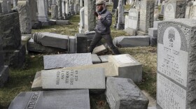 Rabbi Joshua Bolton of the University of Pennsylvania's Hillel center surveys damaged headstones at Mount Carmel Cemetery  in Philadelphia. (Jacqueline Larma/AP)