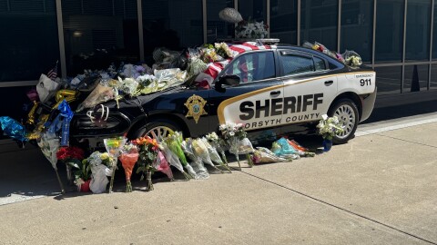 A photo of a Forsyth County Sheriff's vehicle decorated with flowers to honor Deputy Kaleb Mitchell