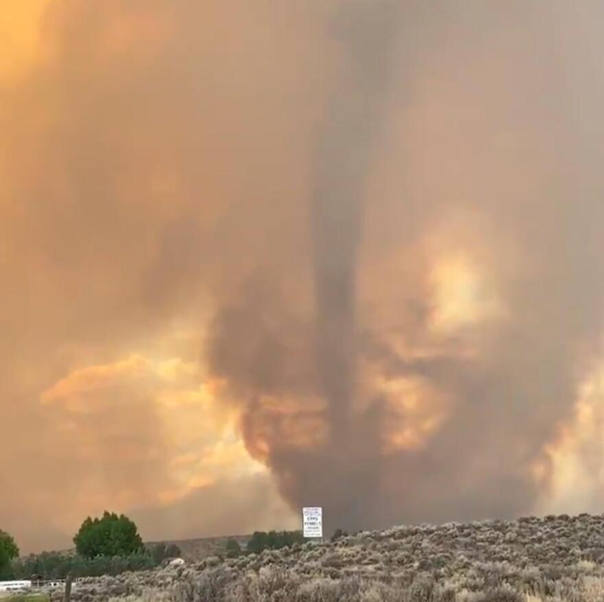 A tornado swirling inside of a wildfire.