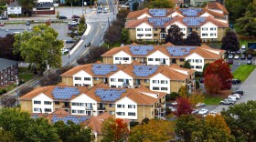 Community with solar panel installed on multifamily homes. multi-family properties with solar power.