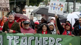 Thousands of teachers and supporters hold signs in the rain during a rally Monday, Jan. 14, 2019, in Los Angeles. (Ringo H.W. Chiu/AP)