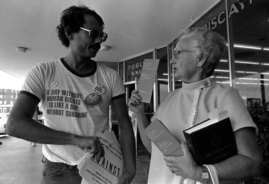Doris Dennis, a volunteer handing out literature for the Save Our Children group headed by Anita Bryant, gets into a debate with Alan Rockway, a volunteer handing out literature for a gay rights group, at a shopping center in Miami in 1977.