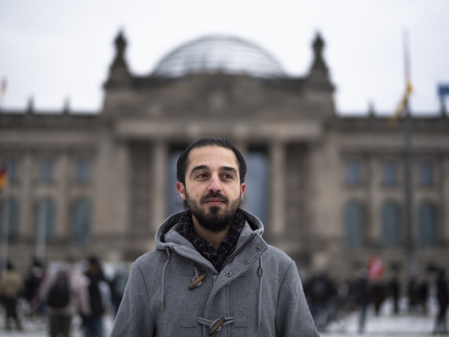 Tareq Alaows stands in front of the Reichstag in Berlin. Alaows came to Germany as an asylum-seeker in 2015 and launched his campaign to run in Germany's federal election in September for the Green Party, but recently withdrew.