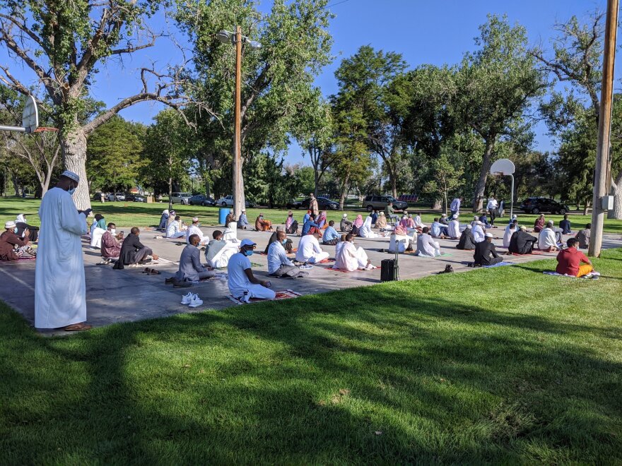 People gather at a park in Fort Morgan to pray during Eid al-Adha