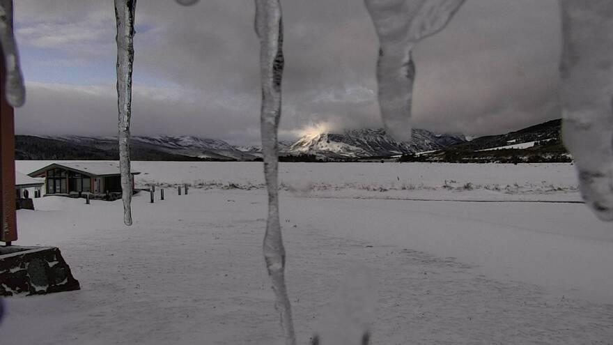 Parts of Montana were hit with more than 2 feet of snow over the weekend, the National Weather Service says. Here, a Glacier National Park webcam shows the sun trying to reach the peaks at the St. Mary Visitor Center, near the Blackfeet Reservation.
