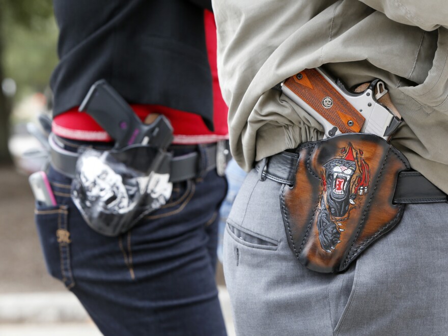 A new survey finds that a majority of Americans, including gun owners, support laws that allow family members or law enforcement to request temporary removal of guns from a person who is seen to be a risk to themselves or others. [Erich Schlegel / Getty Images]