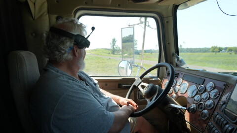 Robert Stobaugh, a rice farmer, looks out at his farm from his big rig.