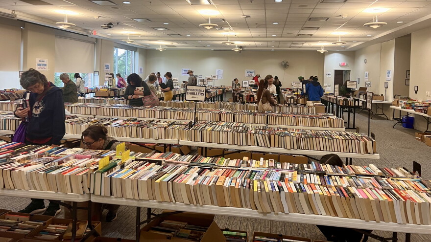 Customers peruse the many tables covered in neatly-lined used books for the Athens-Clarke County Library Fall Book Sale.