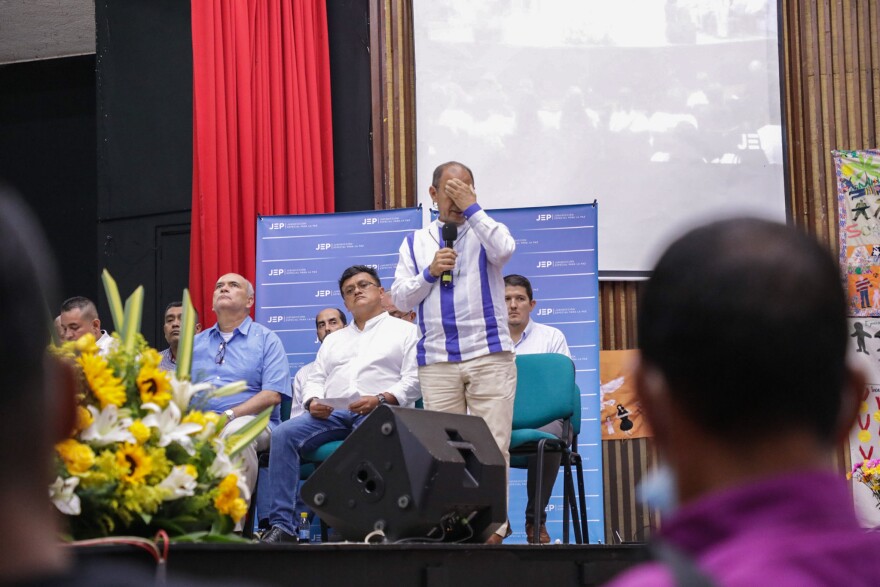 Retired Colombian military commander Paulino Coronado (right) speaks at the special tribunal in which army officers are accused of killing civilians and presenting them as false combat casualties, in Ocaña, Colombia, on April 27.