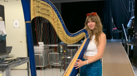 Mikaela Davis poses with her harp before performing live for The Fabulous 413.