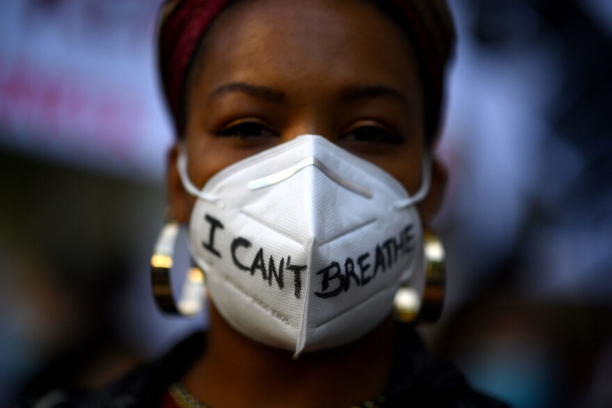 A woman wears a mask reading "I can't breathe" in Madrid, on June 7, 2020, during a demonstration against racism and in solidarity with the Black Lives Matter movement, in the wake of the killing of George Floyd. (GABRIEL BOUYS/AFP via Getty Images)