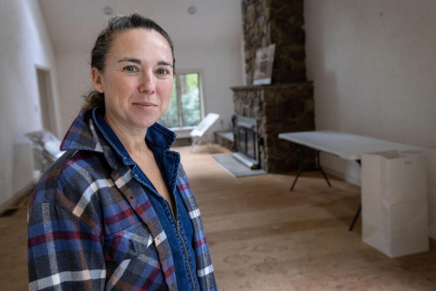 Susie Shaw stands in what will be the main family room at the Green House Retreat in Falmouth, Mass. (Robin Lubbock/WBUR)
