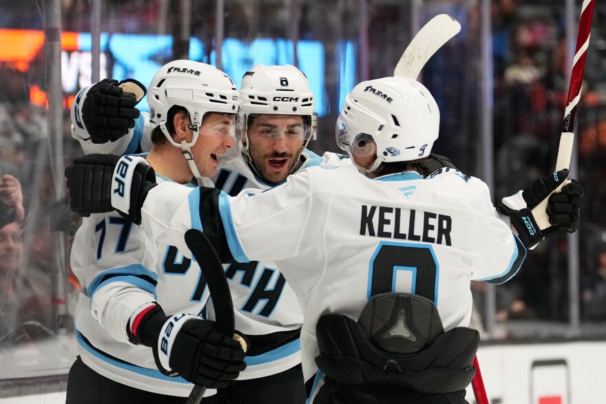 FILE: Utah Mammoth right wing JJ Peterka left, celebrates his goal with center Nick Schmaltz, center, and right wing Clayton Keller during the second period of an NHL hockey game against the Anaheim Ducks, Wednesday, Dec. 3, 2025, in Anaheim, Calif.