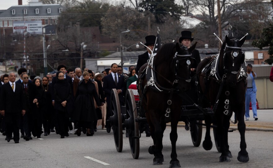 A horse-drawn caravan heads to the Statehouse in Columbia with the casket of Rev. Jesse Jackson.