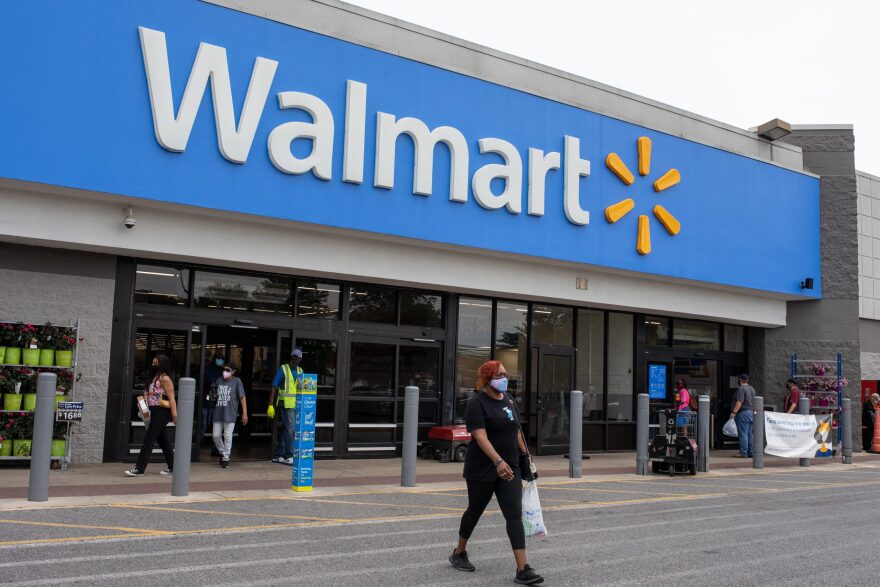 Shoppers walk out of a Walmart store in Maryland May 4. The Occupational Safety and Health Administration has not cited the nation’s largest retailer despite employee complaints, illnesses and deaths at Walmart facilities across the country. The company says there is no proof that employees contracted COVID-19 at work.