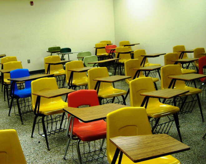 A classroom of empty chairs and desks.
