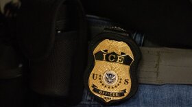 FILE - A federal agent wears an Immigration and Customs Enforcement badge in New York, June 10, 2025. (AP Photo/Yuki Iwamura, File)