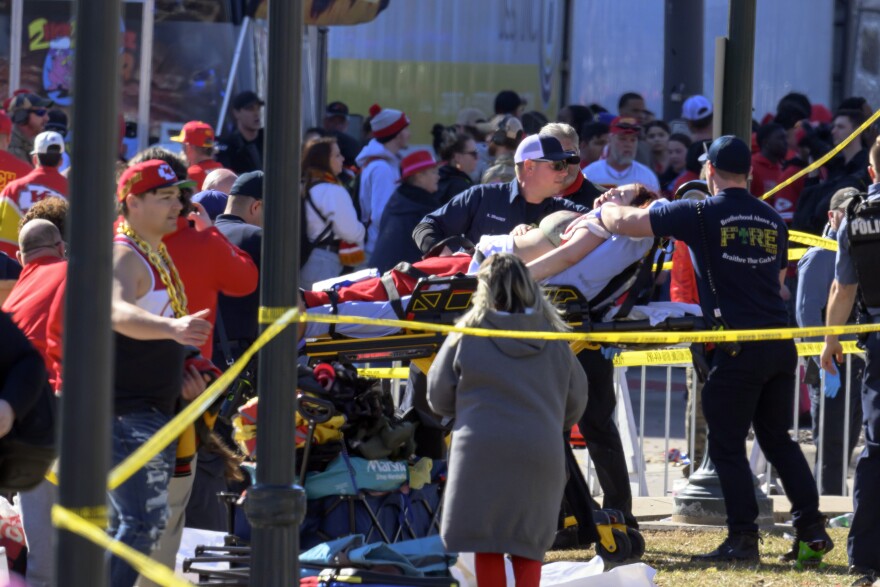 A woman is taken to an ambulance after a shooting following the Kansa City Chiefs Super Bowl celebration in Kansas City, Mo., Wednesday, Feb. 14, 2024.