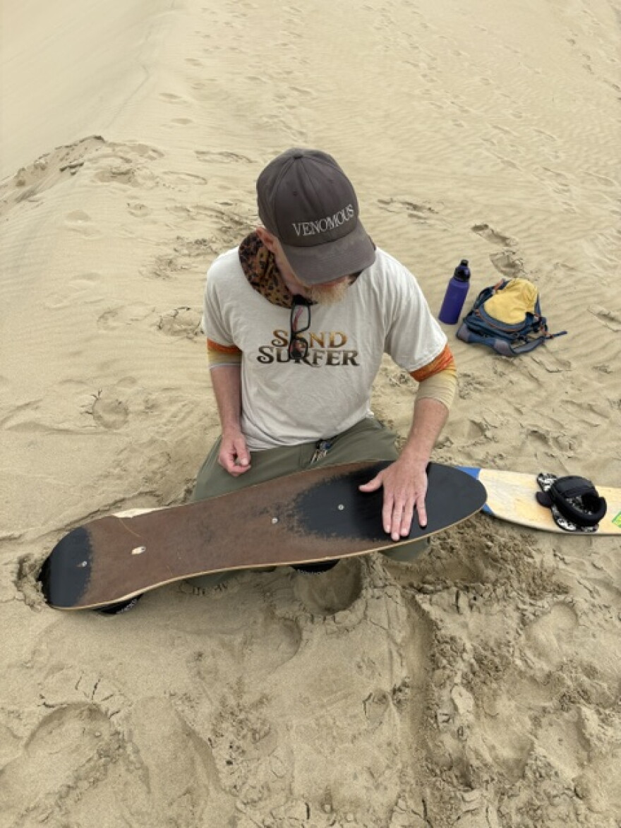 David Edge showing how to wax a sand board