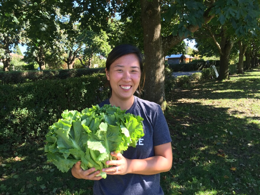 Chef Rachel Yang holds an escarole -- 'Bigger than my head!' -- from the Wallinford Farmers Market.