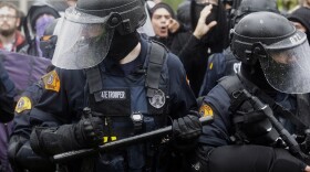 Washington State Troopers try to keep counter-protesters back from a protest by the conservative group Patriot Prayer, Thursday, June 15, 2017, at Evergreen State College in Olympia, Wash. 