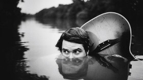 Keller Williams and his guitar peek out being submerged in water