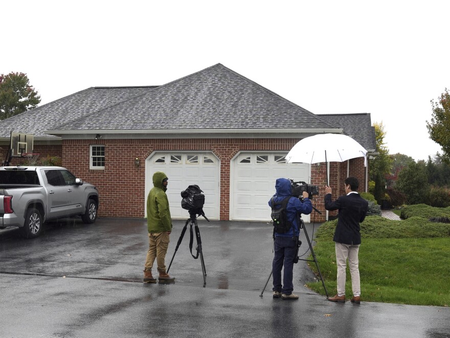News crews film outside the home of Maryland Circuit Court Judge Andrew Wilkinson on Friday in Hagerstown, Md. Authorities say Wilkinson, who was shot to death in the driveway of his home, had presided over the divorce case of the man now identified as a suspect in the killing.