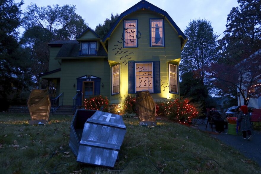 A home decorated for Halloween with bats and coffins.