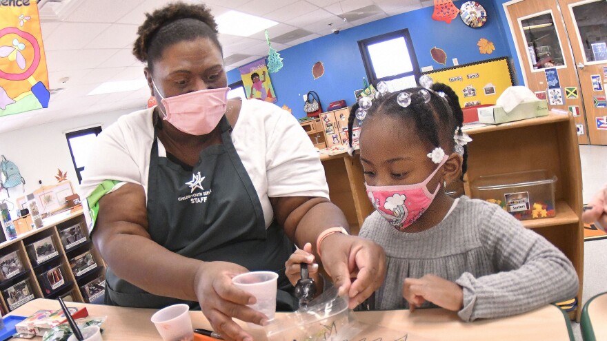 Strong Beginnings Program Assistant Judy Jones works with Madison Easter during a holiday craft-making activity in December at Fort Lee’s Battle Drive Child Development Center. It was recently announced that the Child and Youth Services program here had been awarded DOD certification, an acknowledgement that it meets the department’s stringent training, health and safety standards for providing military childcare. (U.S. Army Photo by T. Anthony Bell)