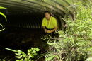 Benjamin Bradley sits in a culvert designed to keep Appalachian brook trout safe from road runoff.
