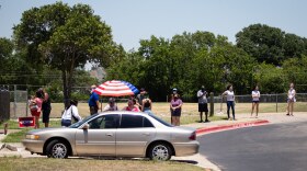 Voters wait to enter Pflugerville ISD's Rock Gym on Election Day.