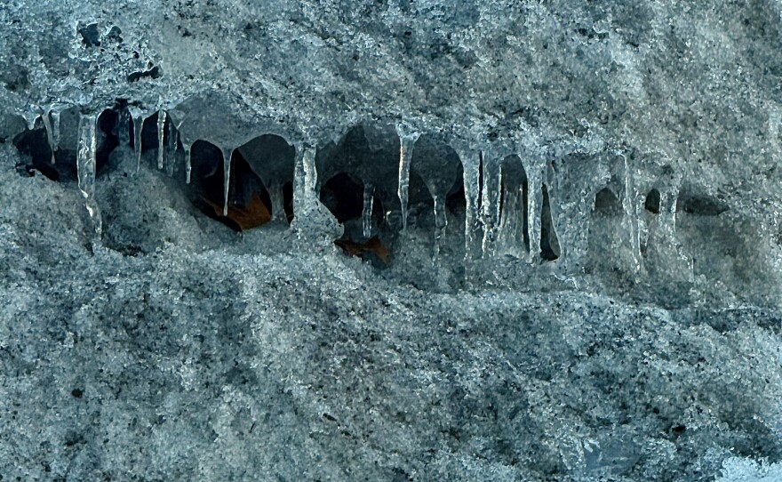 Icicles hang from inside a parking lot snow pile near the Twin Cities on Feb. 6, 2026.