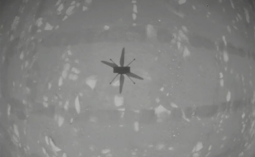 In this image from NASA, NASA's experimental Mars helicopter Ingenuity hovers above the surface of Mars on Monday. The little 4-pound helicopter rose from the dusty red surface into the thin Martian air Monday, achieving the first powered, controlled flight on another planet.